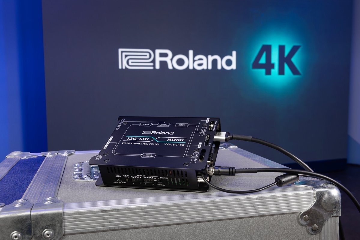 銀色の機材ケース上に置かれたRoland VC-1SC-4Kと、背景のRoland 4Kロゴ